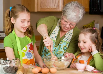 older-woman-near-two-little-girls-cooking. alert1 medical alert system older-woman-near-two-little-girls-cooking. alert1 medical alert system